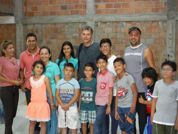 Families and volunteers gathered together at a community program site