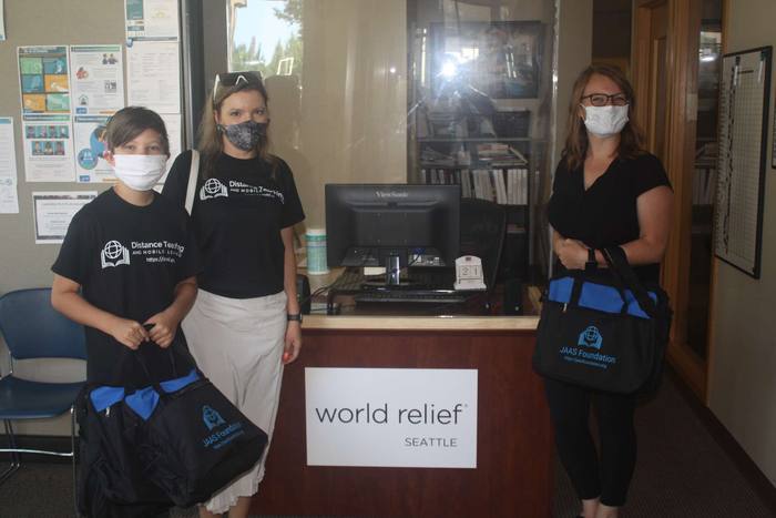 Volunteers delivering donated laptops to the World Relief office in Seattle