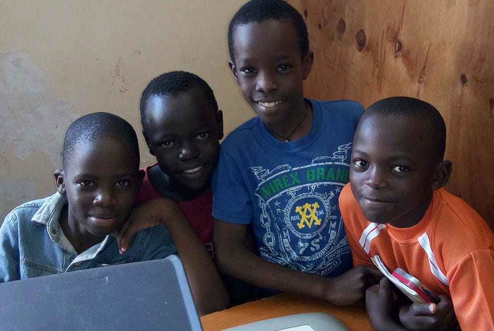 Young boys pose for picture during in DTML Computer lab in Luwero